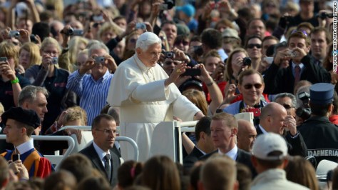 Benedict waves to pilgrims as he arrives at St. Peter's Square for his weekly address in October 2012.