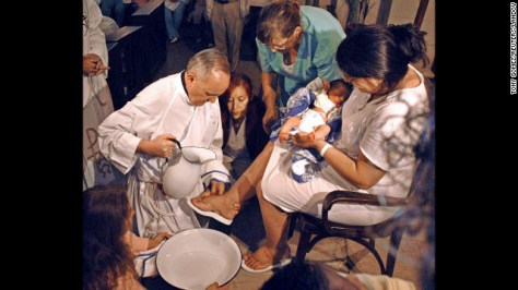 Bergoglio is shown washing the feet of a woman on Holy Thursday at the Sarda maternity hospital in Buenos Aires in 2005